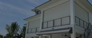 Defender hurricane impact screens lowered over a home